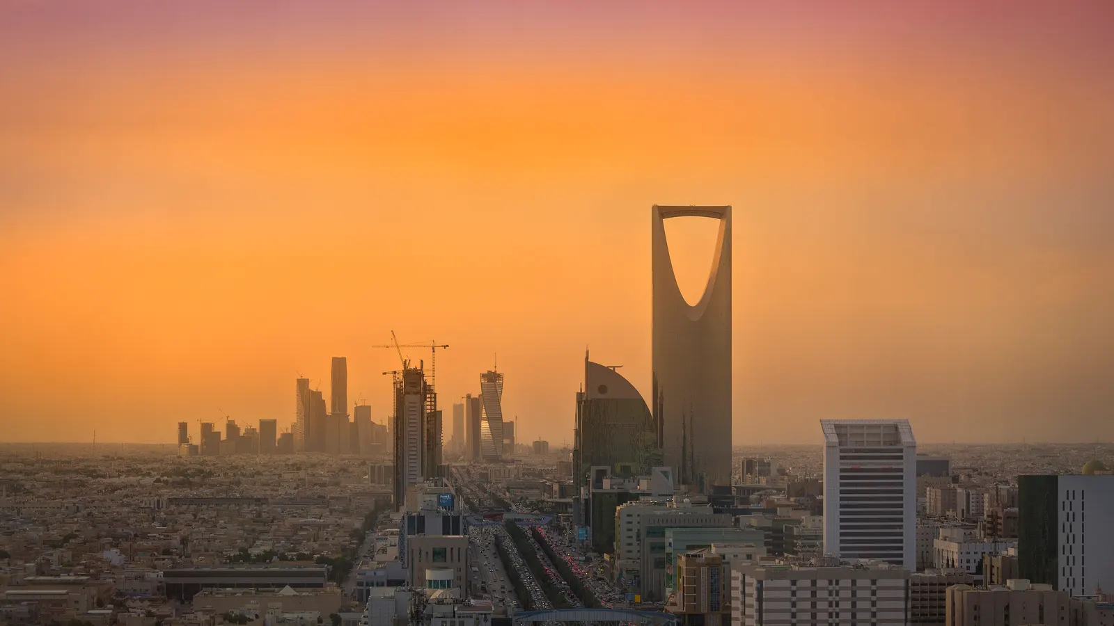 The Riyadh skyline with the King Abdullah Financial District and Kingdom Tower; illustrative photograph, not of the summit
